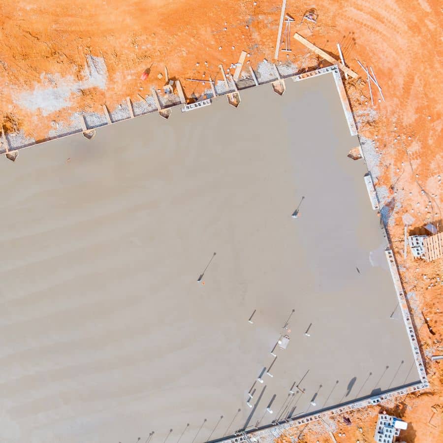 Having discussed the different types of commercial concrete foundations and their applications, we now turn our attention to the initial steps in the process: site preparation and soil analysis.